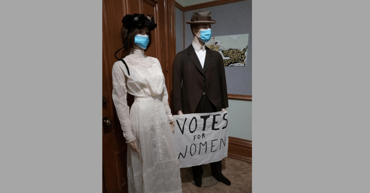 One of the displays at the Merced County Courthouse Museum “Beyond Appearance: Portraits of Merced County Women” exhibit shows two mannequins dressed in period costume, and wearing face masks. Photo: Steve Newvine 