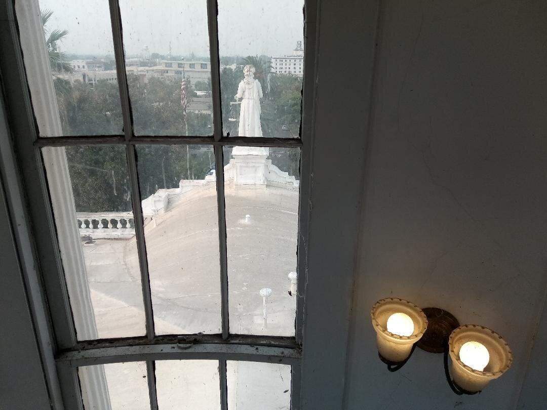  Downtown Merced on a not-so clear day. This is the view from the cupola on top of the Merced County Courthouse Museum looking down N Street toward downtown. The statue is of the Roman Goddess Justica, but without the blindfold; a creative choice by the building architect who, according to the architectural history of the building, did not believe justice is blind. Photo: Steve Newvine 