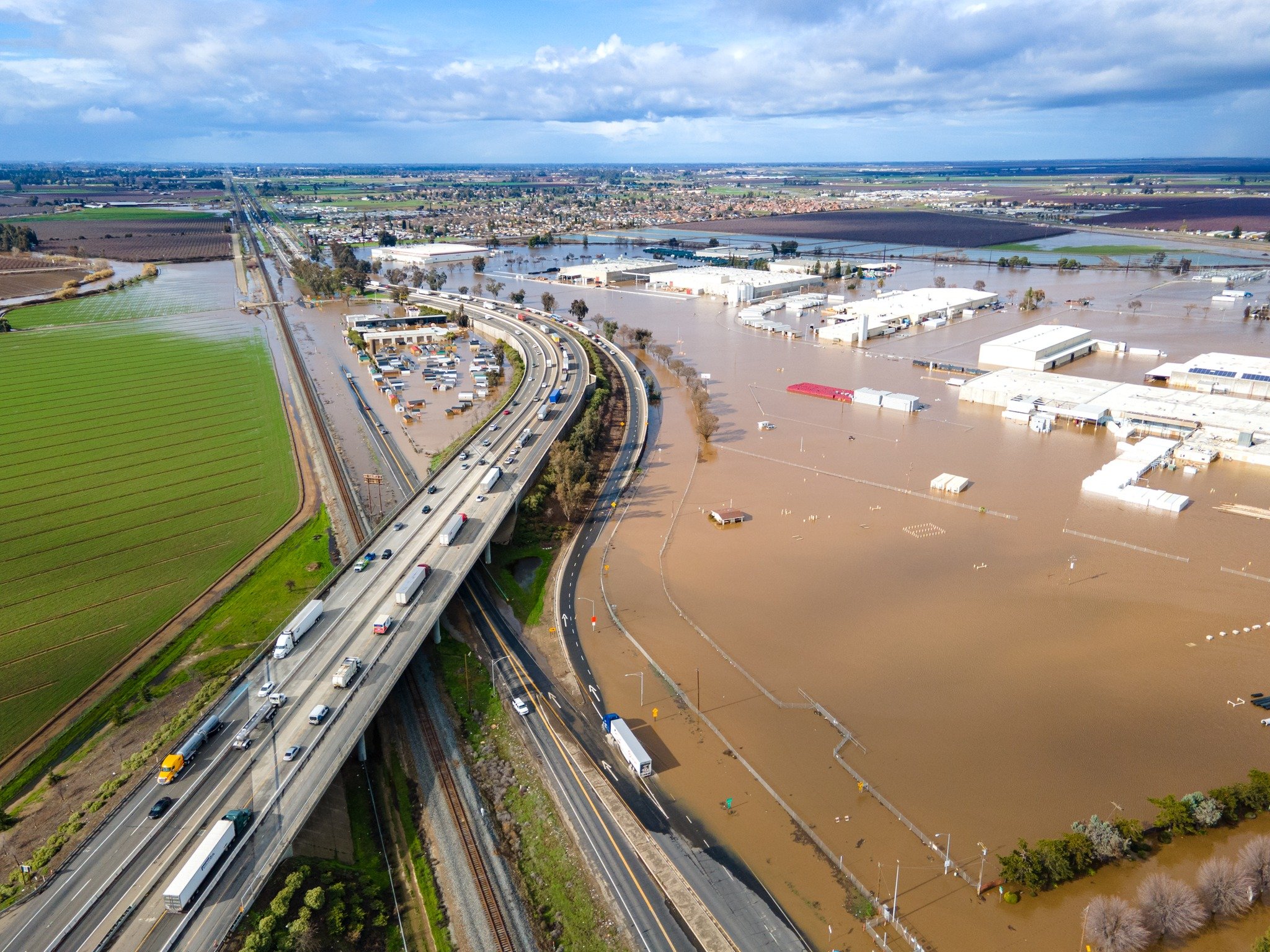 This photo provided by the County of Merced, shows how flood waters covered lower land near Ashby Road off California Highway 99. Photo: County of Merced Facebook page.