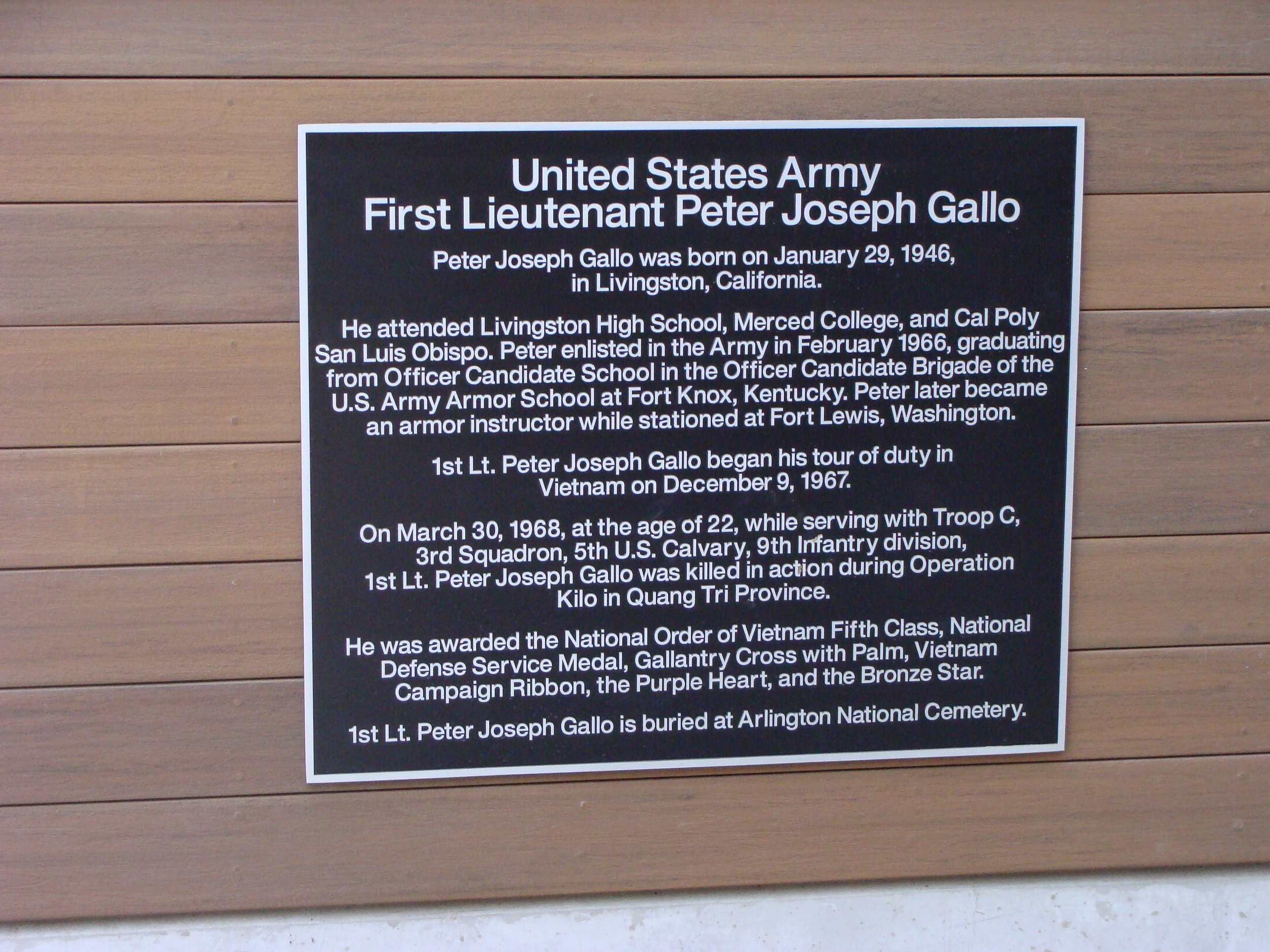  Plaque behind the entrance sign at the First Lieutenant Peter Joseph Gallo Veterans Resource Center at Merced College.  Photo by Steve Newvine 