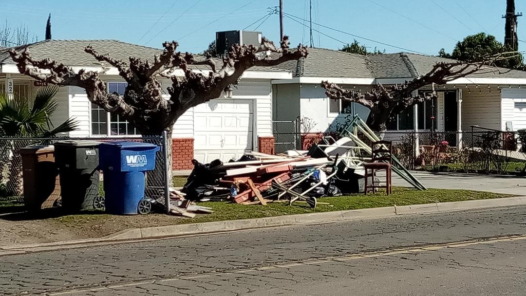 Residents in Planada are now putting water damaged furniture and building materials on the curb for pick up by County crews taking it all to a landfill. Photo: Steve Newvine