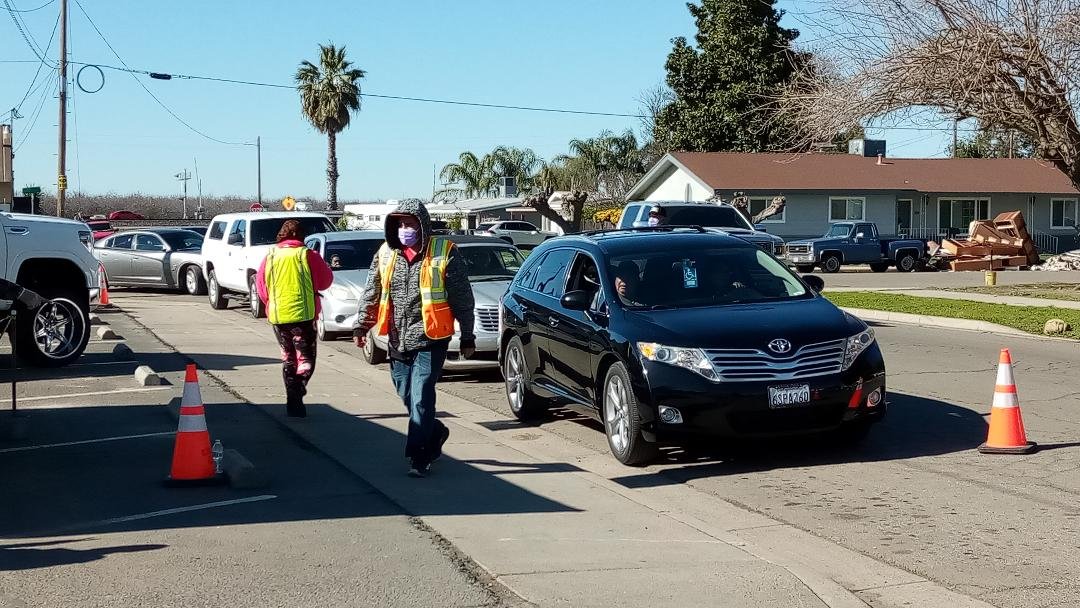 Volunteers pass out containers of hot meals for citizens working on getting their homes back in living condition. Photo: Steve Newvine