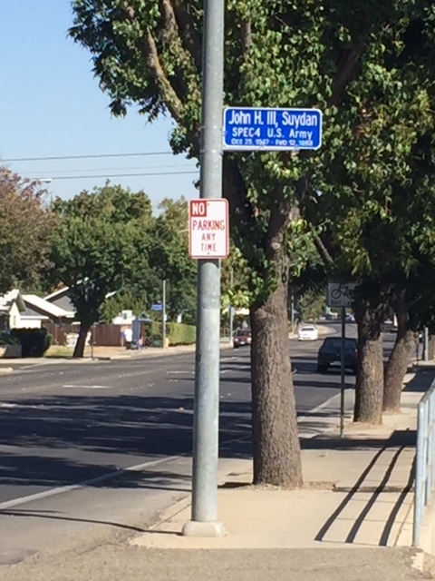  These white on blue signs are on utility poles up and down M Street. Each one recognizes the service of a soldier from the City of Merced. Photo: Steve Newvine 