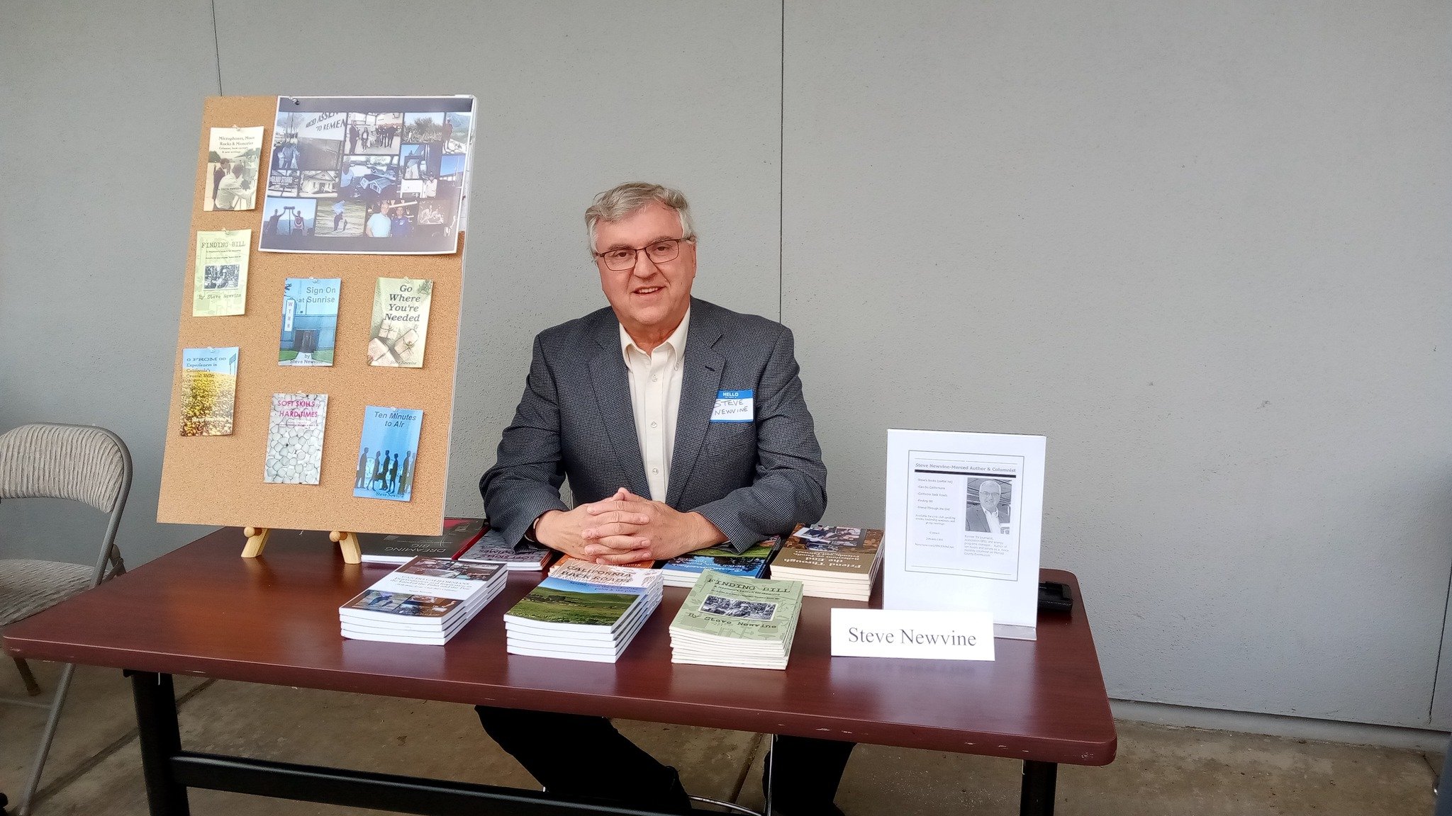 My table at the Local Author Fair included several of my books and a display of book covers.
